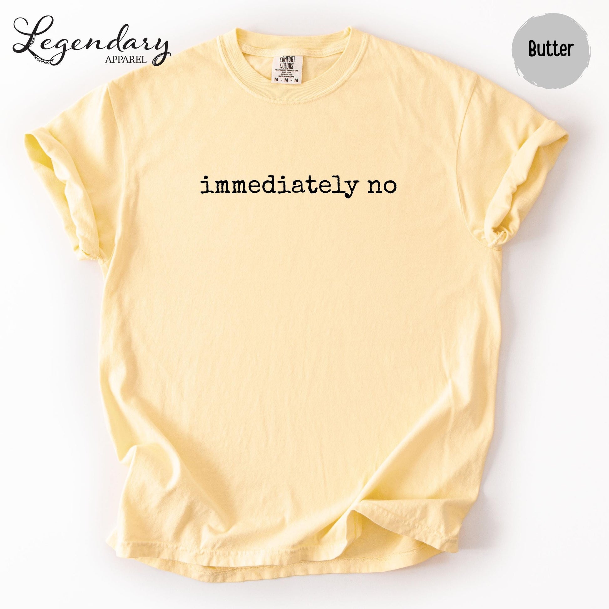 A yellow t-shirt with the text "immediately no" printed on it.