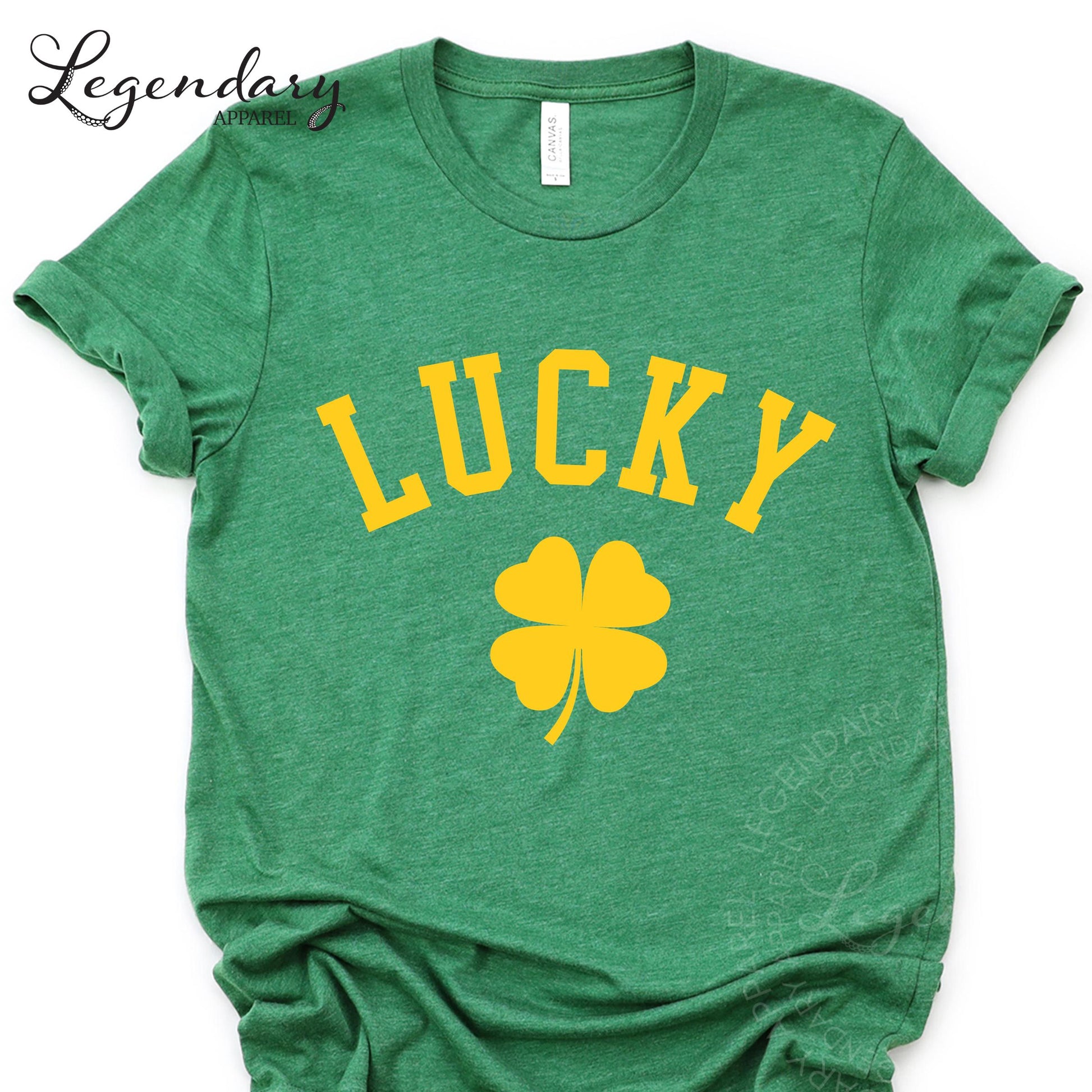 A green t-shirt with the word "Lucky" printed on it, along with a yellow four-leaf clover symbol.