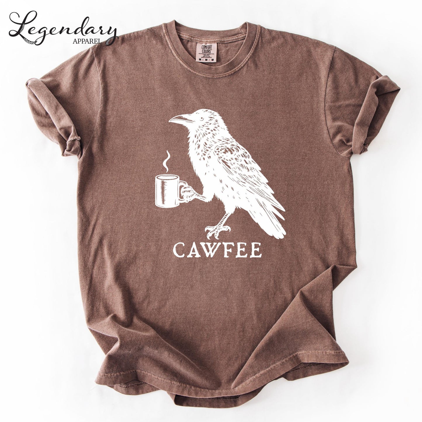 a brown t-shirt with a white graphic design depicting a bird holding a cup of coffee.