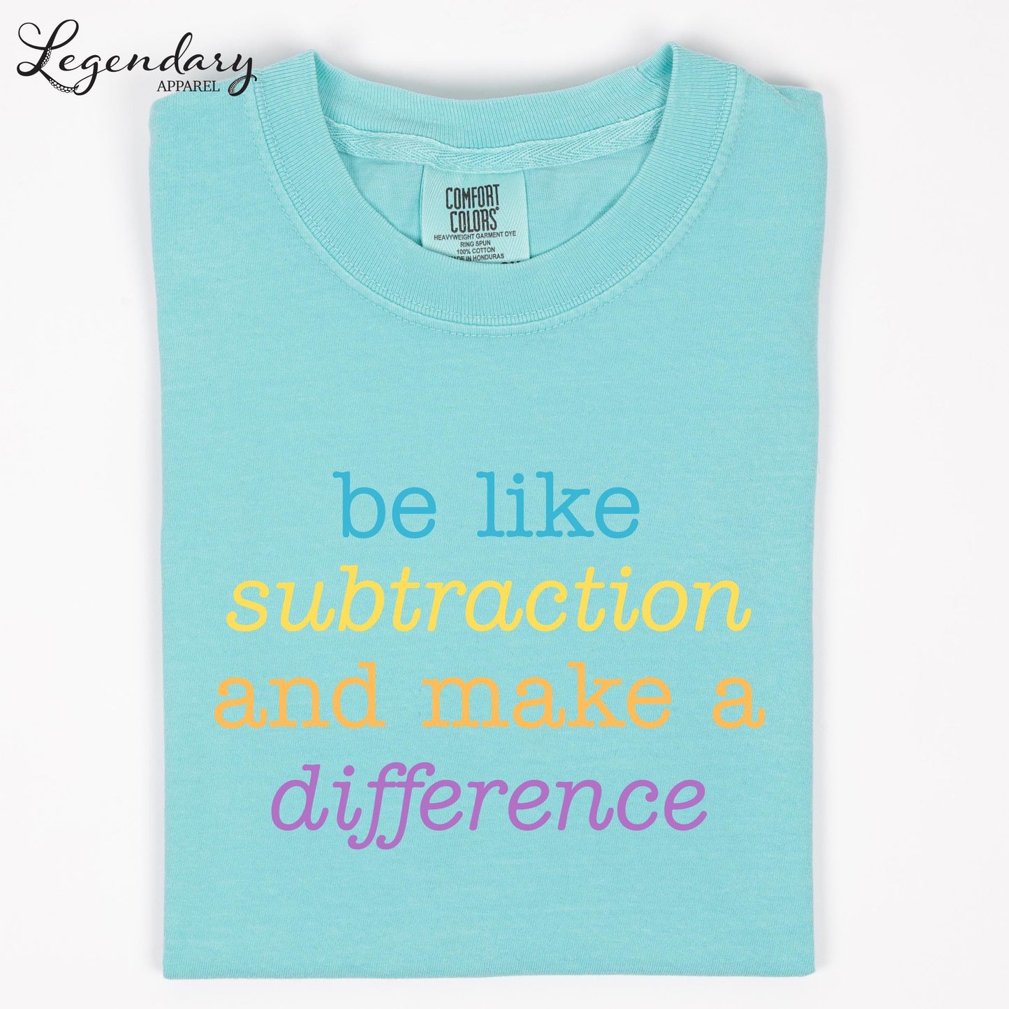 A turquoise t-shirt with the text "be like subtraction and make a difference" printed on it.
