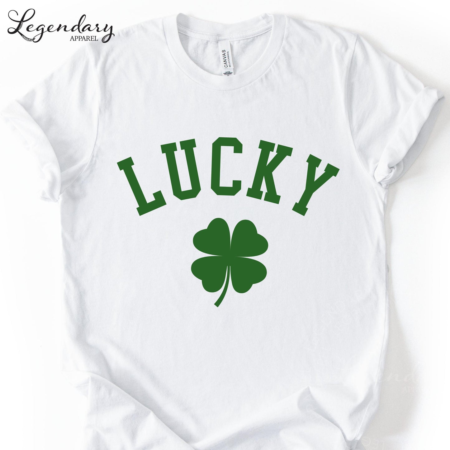 A white t-shirt with the word "Lucky" printed on it, along with a green clover symbol.
