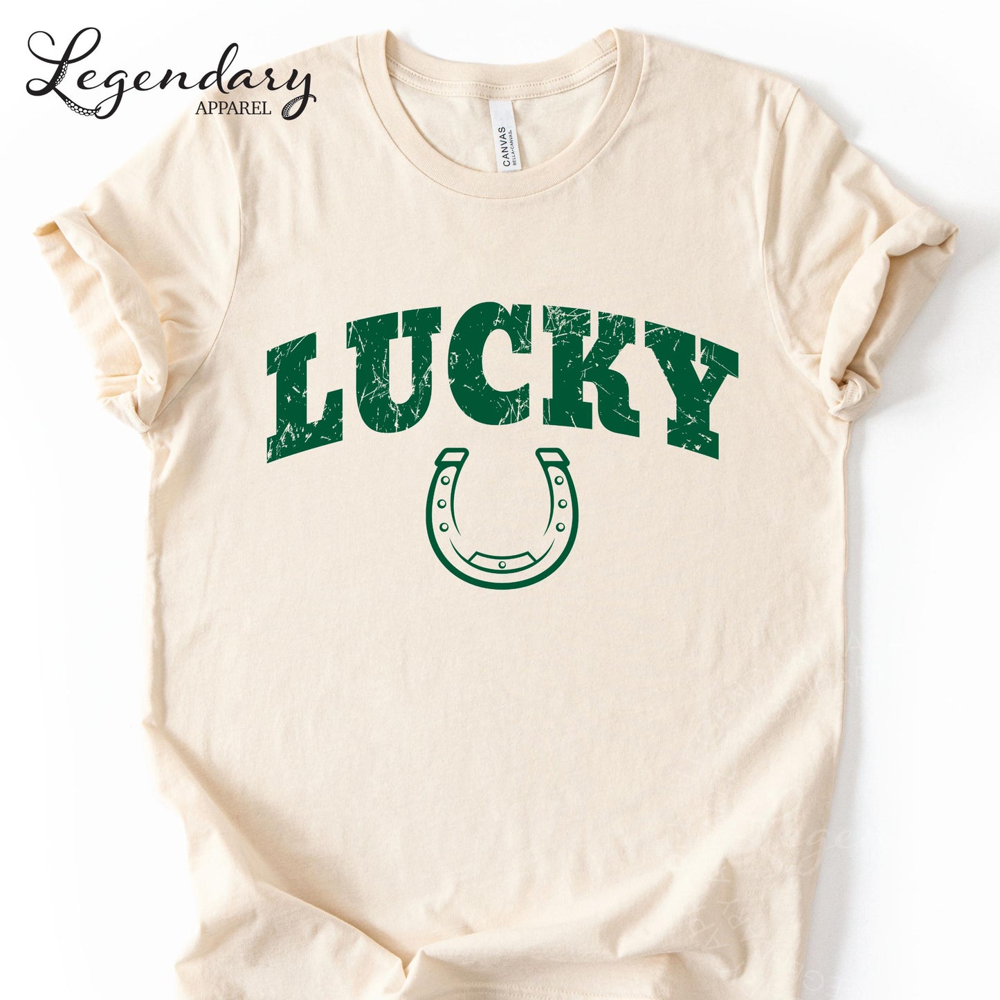 A cream-colored t-shirt with the word "Lucky" printed in green letters, along with a horseshoe graphic.