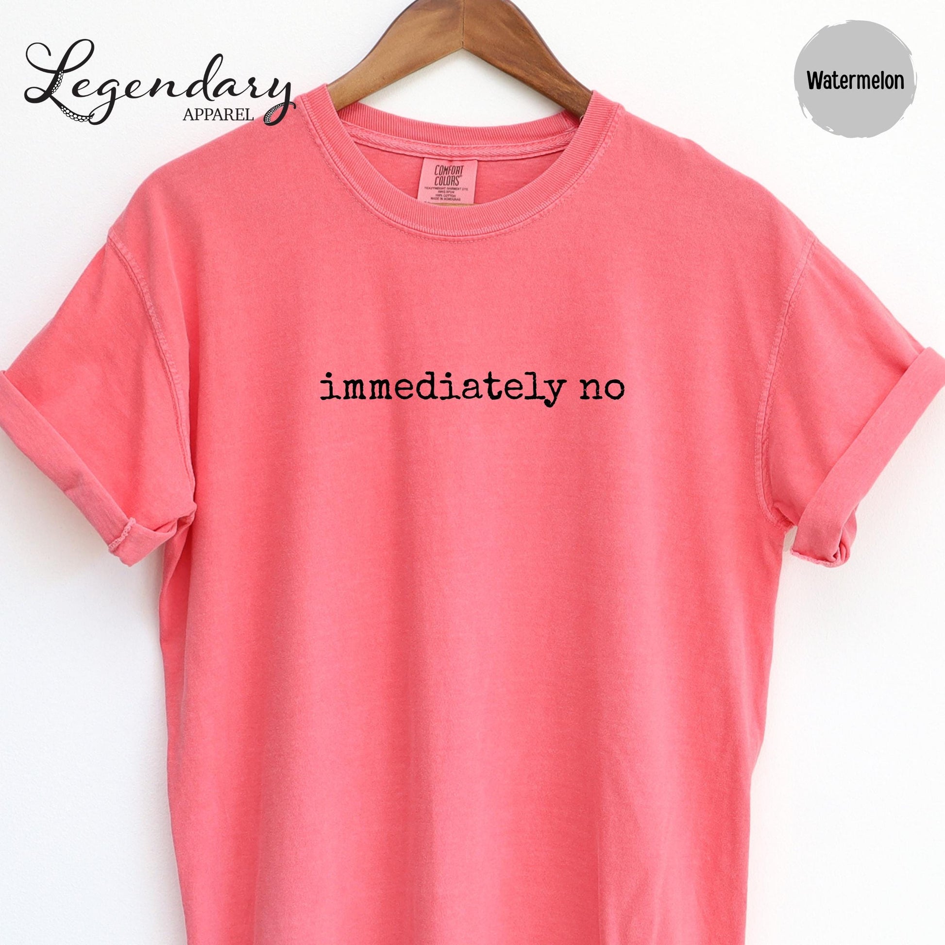 A bright pink t-shirt with the text "immediately no" printed on it.