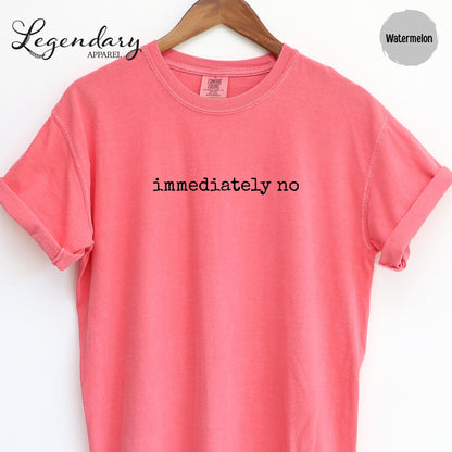 A bright pink t-shirt with the text "immediately no" printed on it.
