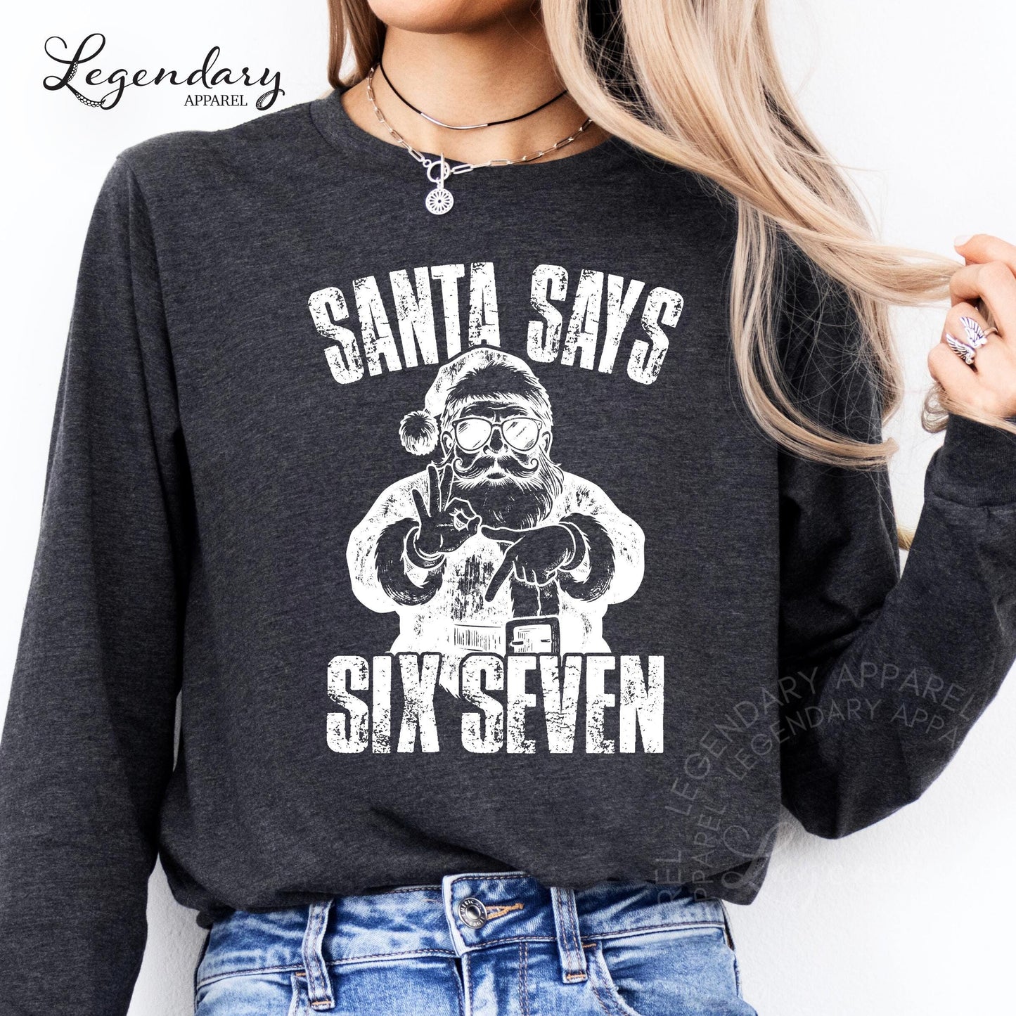 A person wearing a gray sweatshirt with a graphic design that says &quot;Santa says six seven&quot; printed on it.