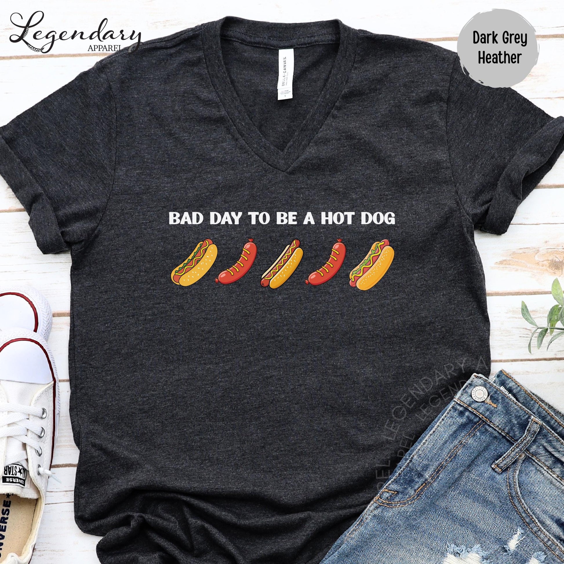 a black t-shirt with a humorous text printed on it, along with a pair of jeans and a pair of sneakers.