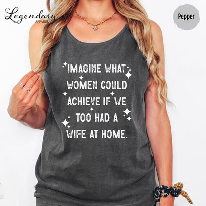 A woman wearing a gray tank top with white text printed on it.