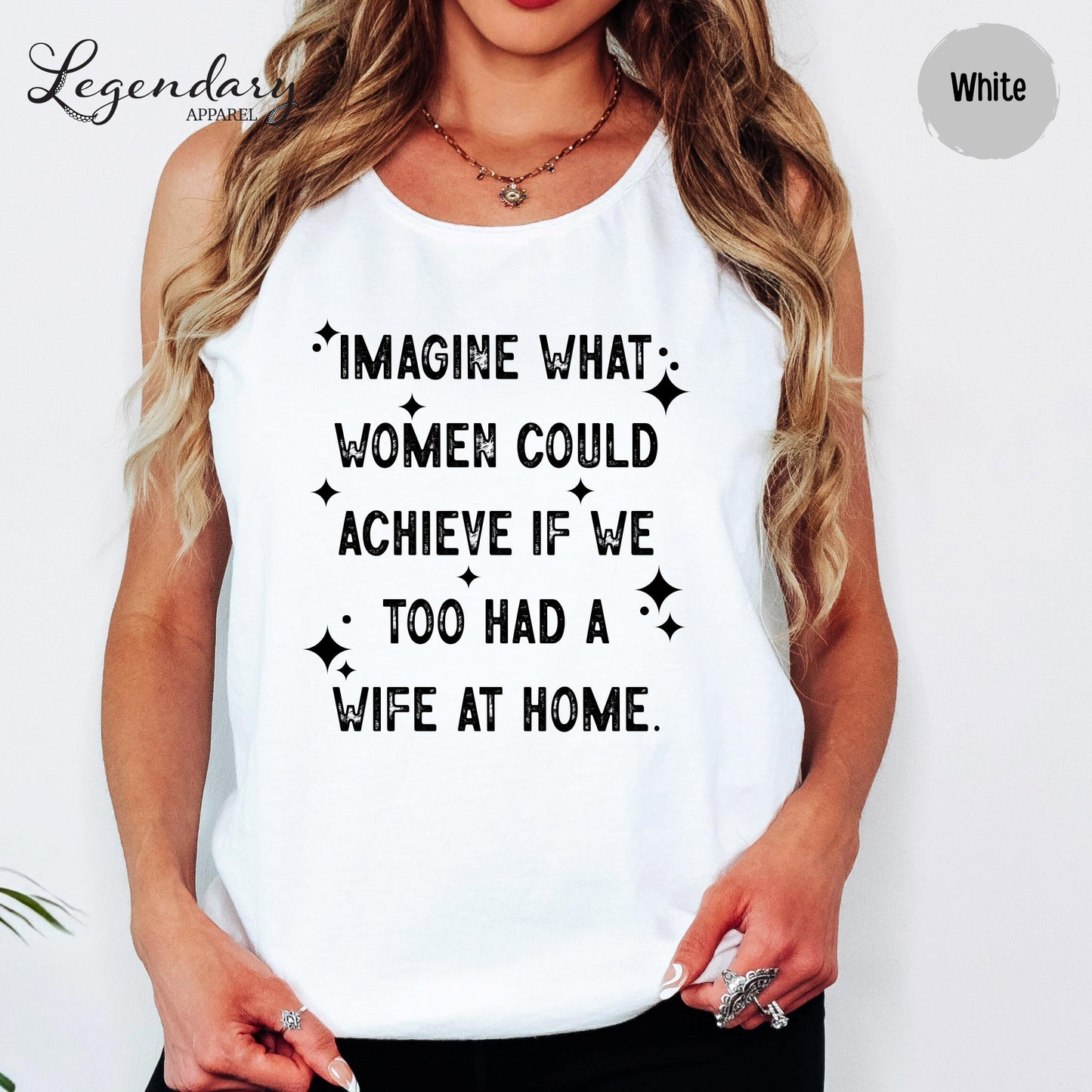 A woman wearing a white tank top with a humorous text printed on it.