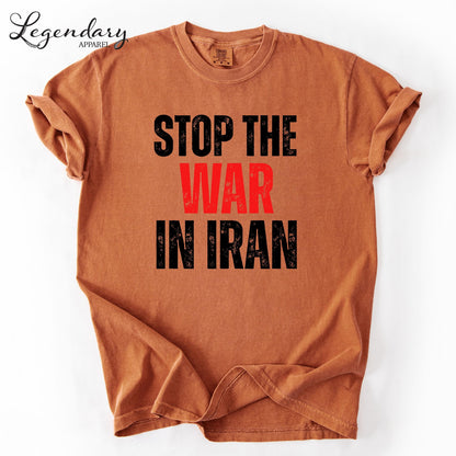 a brown t-shirt with the text "STOP THE WAR IN IRAN" printed on it in a bold, red font.