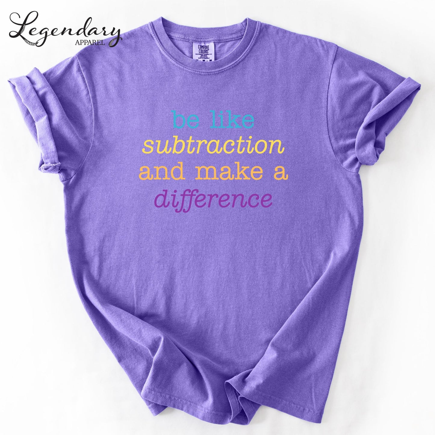 A purple t-shirt with the text "be like subtraction and make a difference" printed on it.