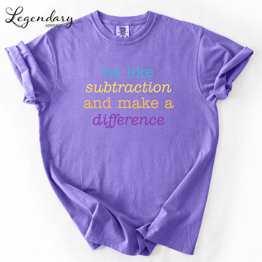 A purple t-shirt with the text "be like subtraction and make a difference" printed on it.