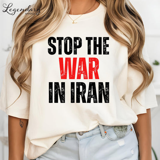 A woman wearing a white t-shirt with the text "STOP THE WAR IN IRAN" printed on it.