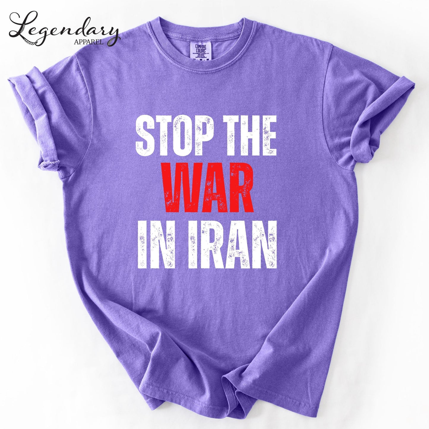 A purple t-shirt with the text "STOP THE WAR IN IRAN" printed on it.