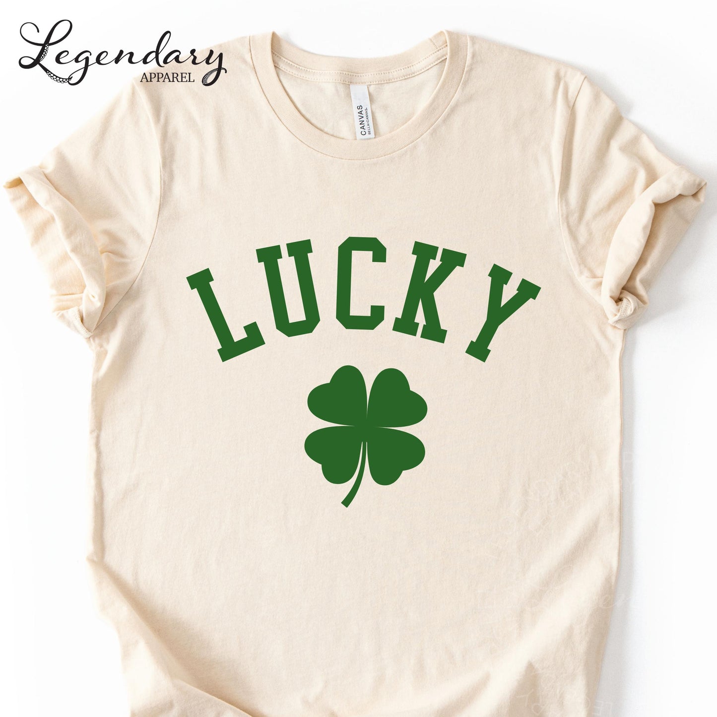 A cream-colored t-shirt with the word "Lucky" printed in large green letters, along with a green clover symbol.