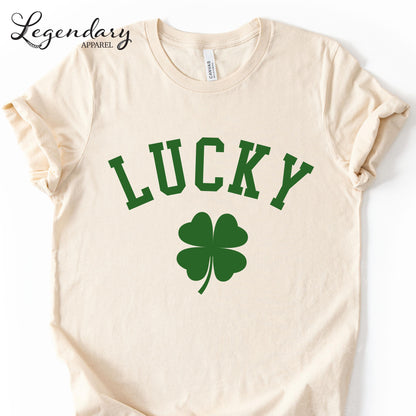 A cream-colored t-shirt with the word "Lucky" printed in large green letters, along with a green clover symbol.