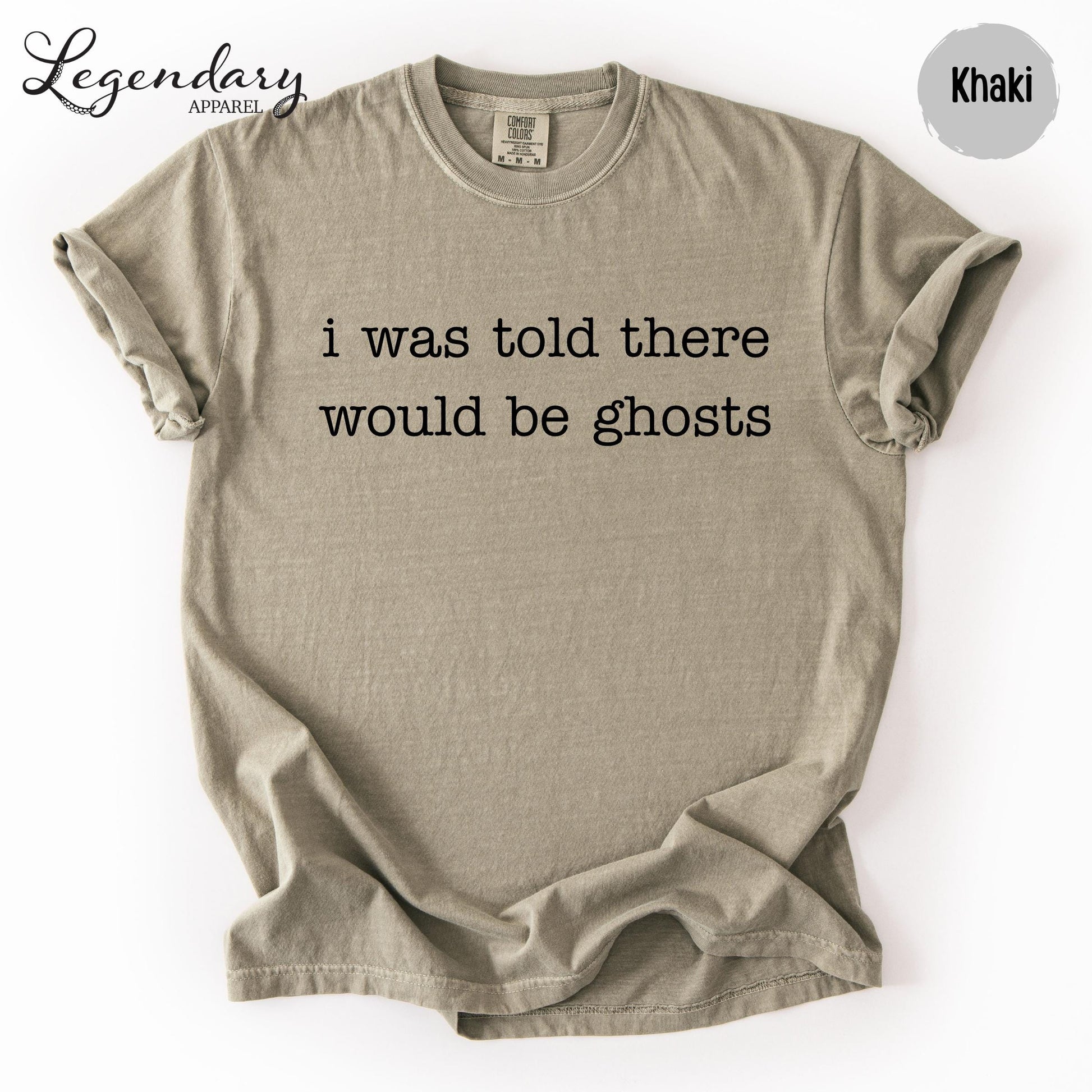 A beige t-shirt with the text "I was told there would be ghosts" printed on it.