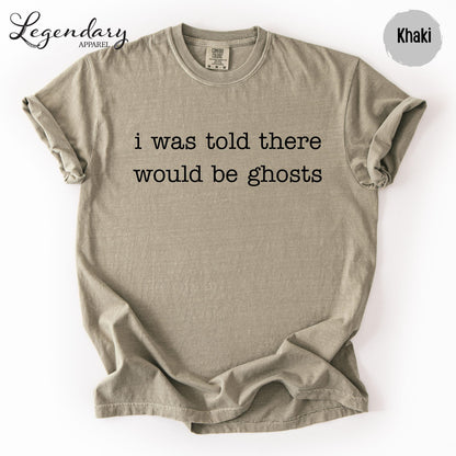 A beige t-shirt with the text "I was told there would be ghosts" printed on it.