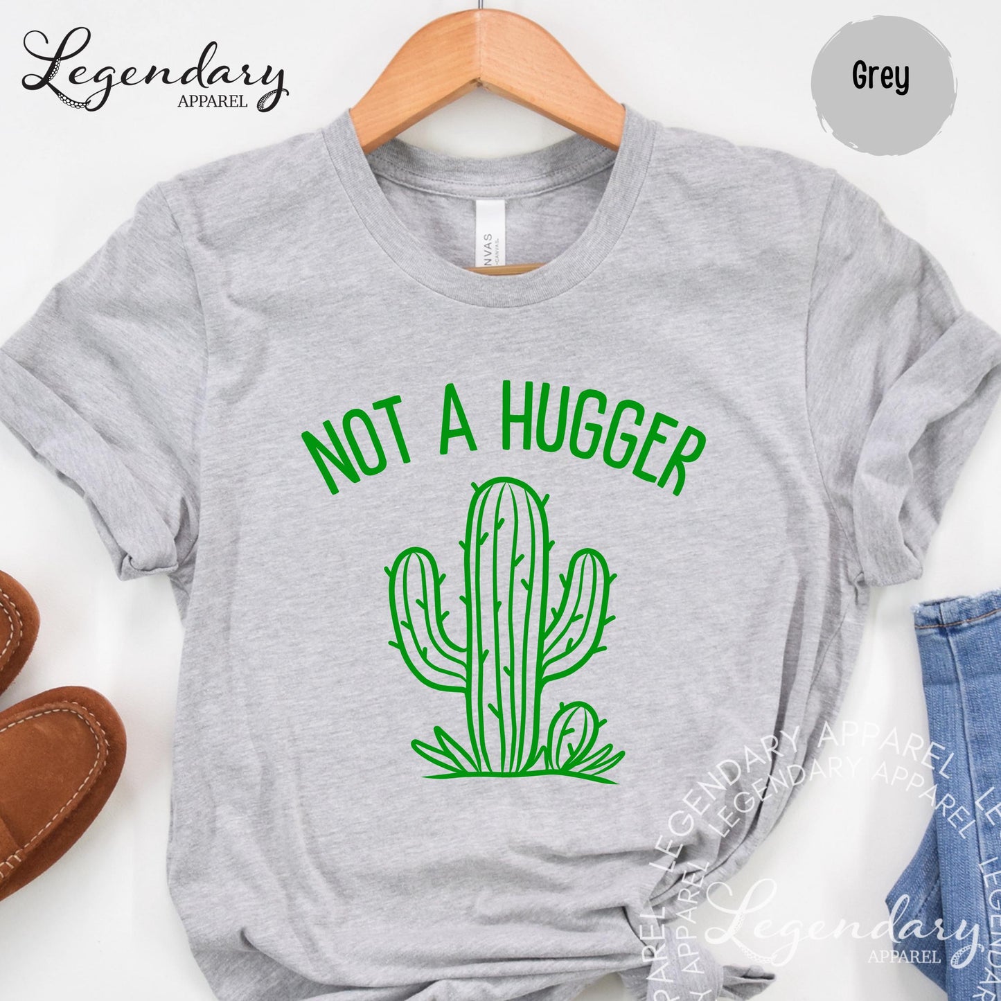 A grey t-shirt with a green graphic of a cactus and the text "NOT A HUGGER" printed on it.