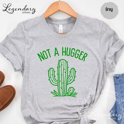 A grey t-shirt with a green graphic of a cactus and the text "NOT A HUGGER" printed on it.