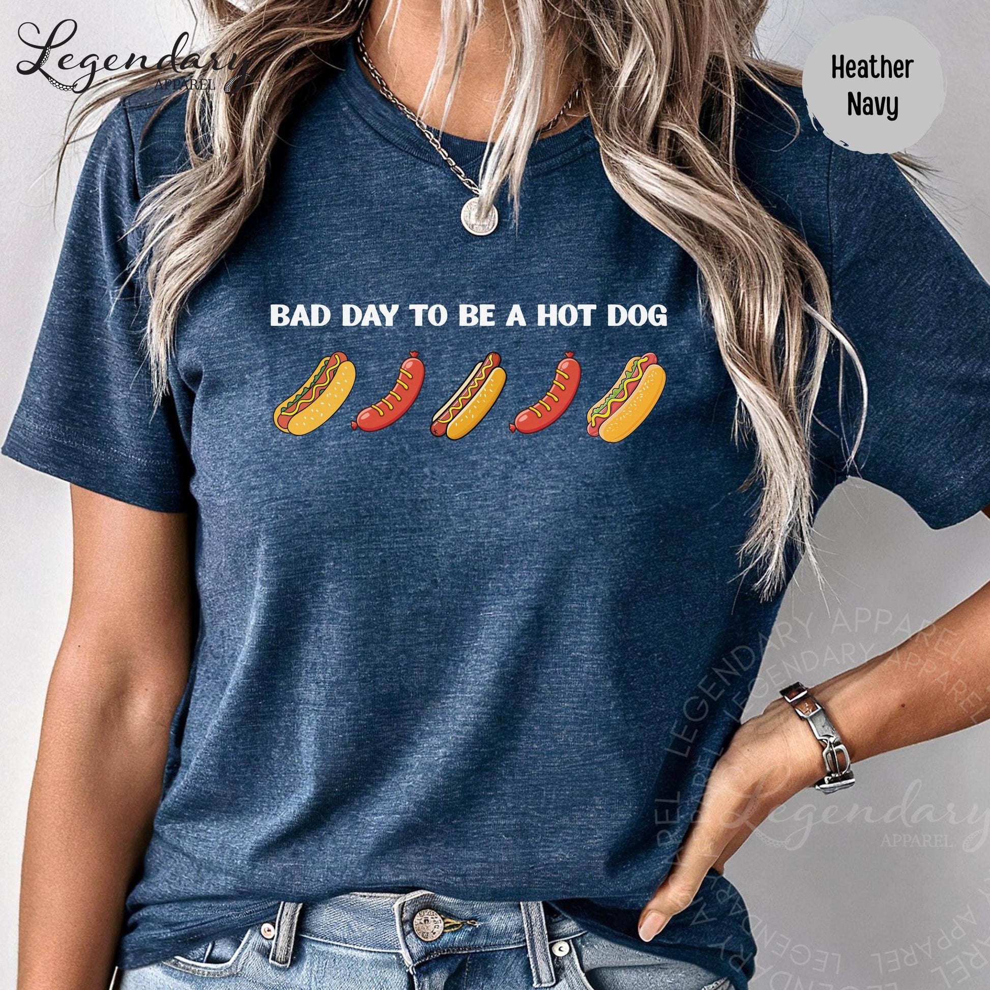 A woman wearing a blue t-shirt with a graphic design of hot dogs and the text "Bad day to be a hot dog".