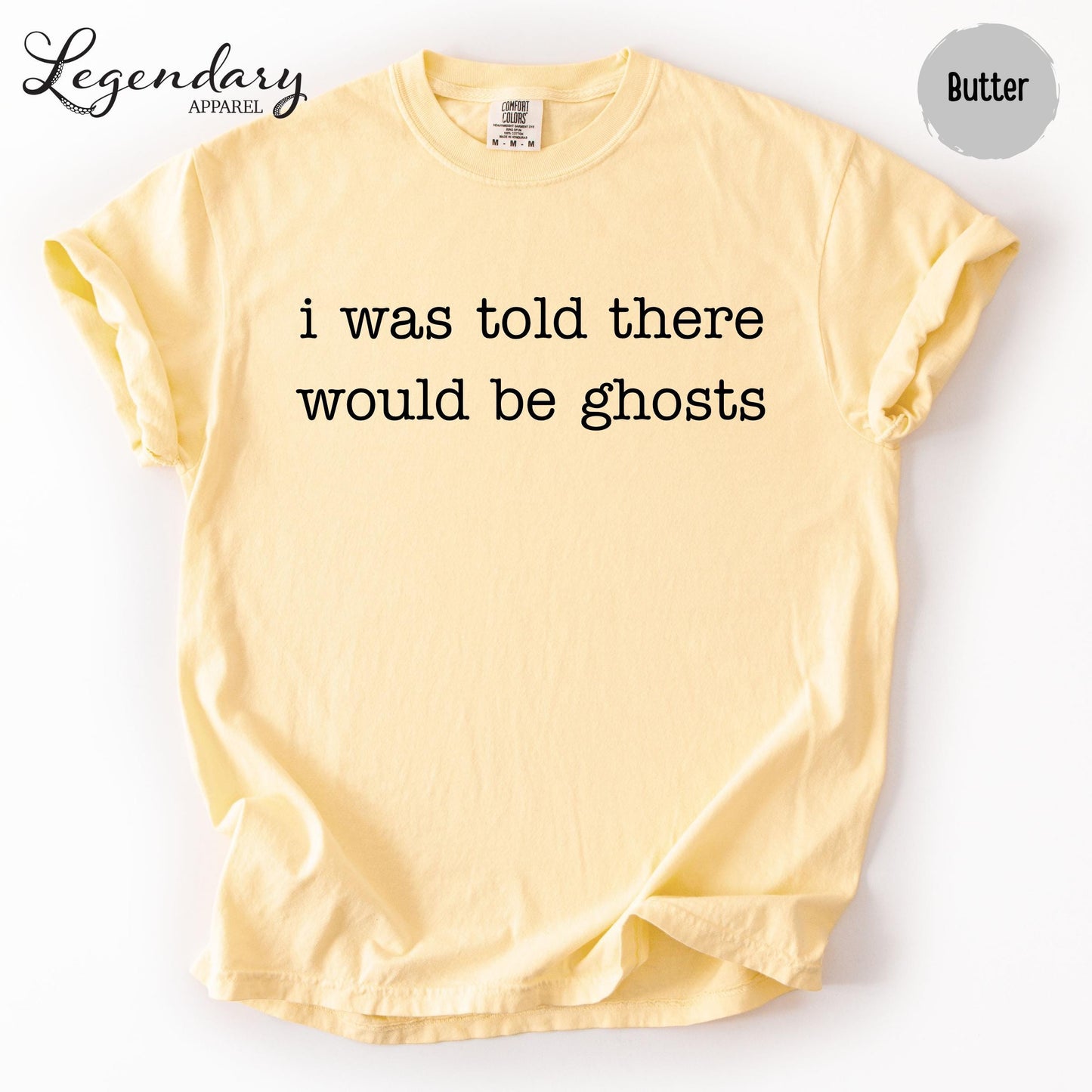 A yellow t-shirt with the text "I was told there would be ghosts" printed on it.