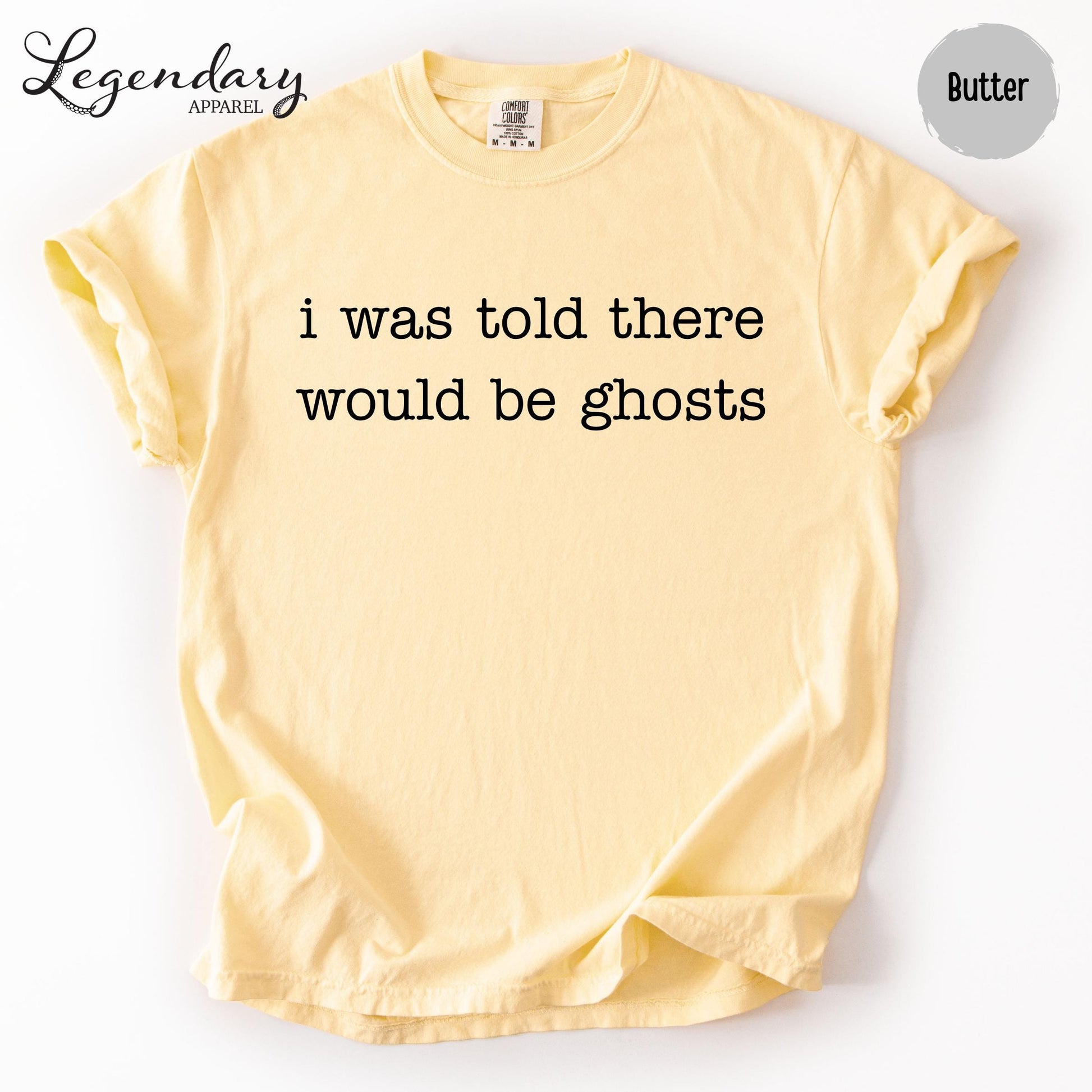A yellow t-shirt with the text "I was told there would be ghosts" printed on it.