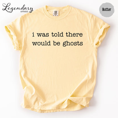 A yellow t-shirt with the text "I was told there would be ghosts" printed on it.