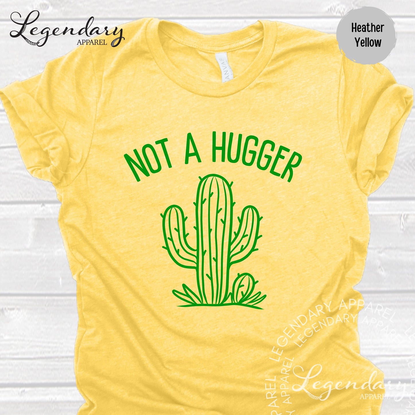 A yellow t-shirt with a green graphic of a cactus and the text "NOT A HUGGER" printed on it.