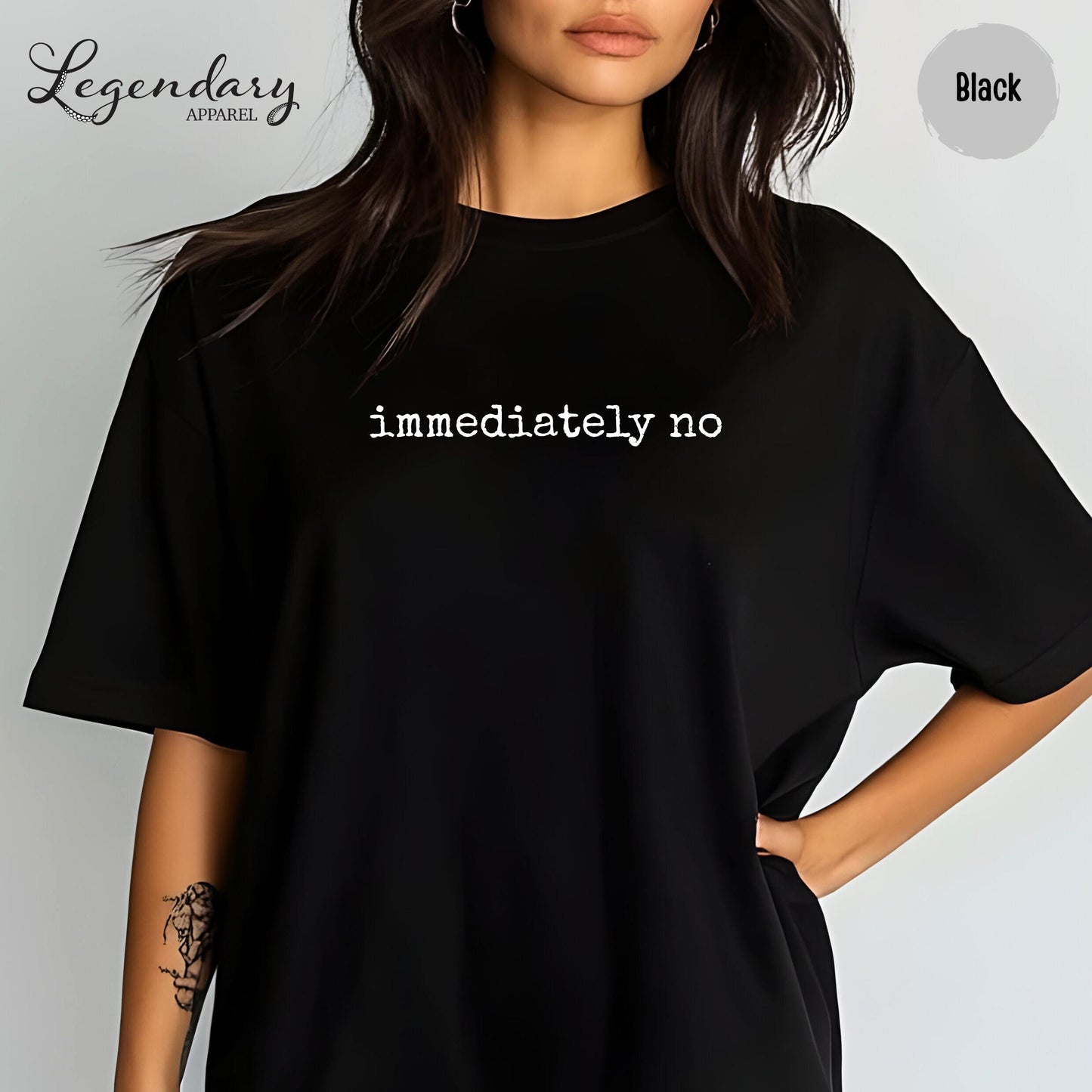 A woman wearing a black t-shirt with the text "immediately no" printed on it.