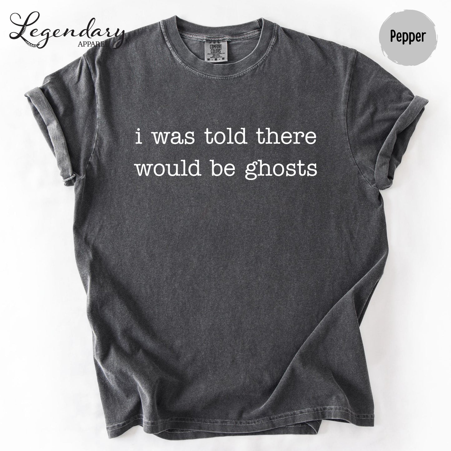 A gray t-shirt with the text "I was told there would be ghosts" printed on it.