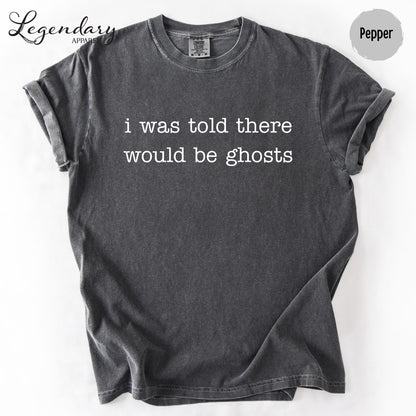 A gray t-shirt with the text "I was told there would be ghosts" printed on it.