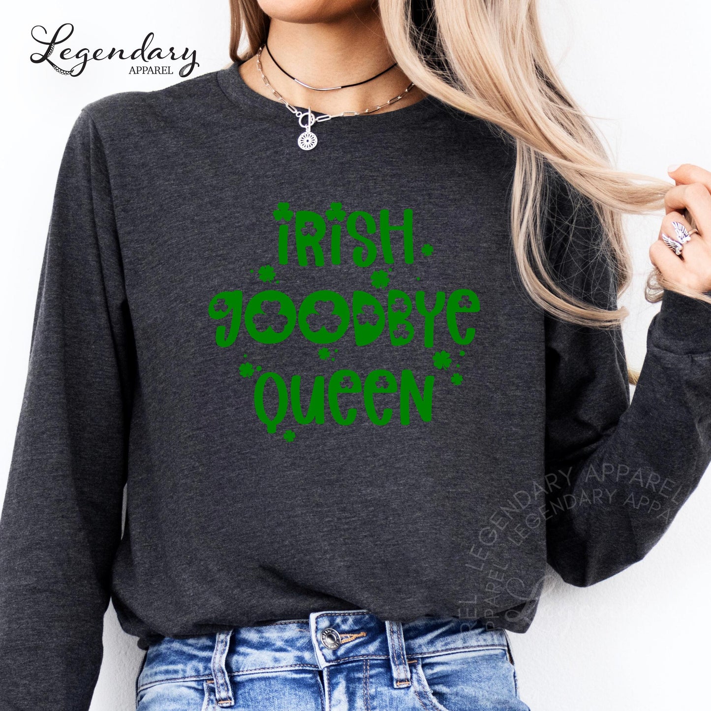 A woman wearing a gray long-sleeved shirt with a green text design that says "Irish Queen" printed on it.