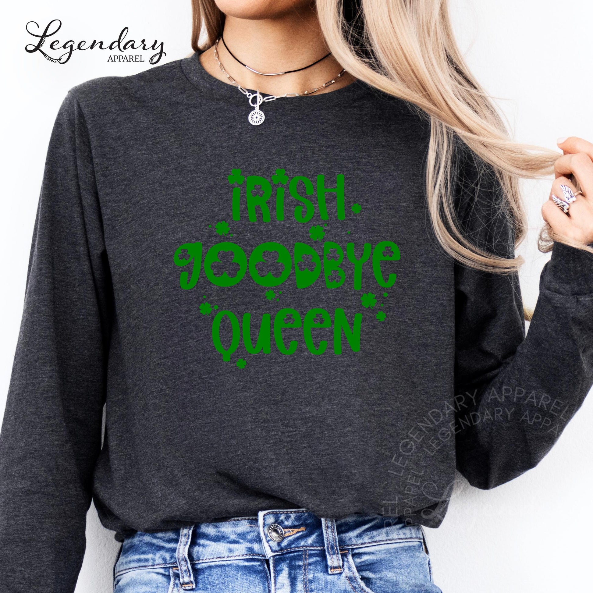 A woman wearing a gray long-sleeved shirt with a green text design that says "Irish Queen" printed on it.