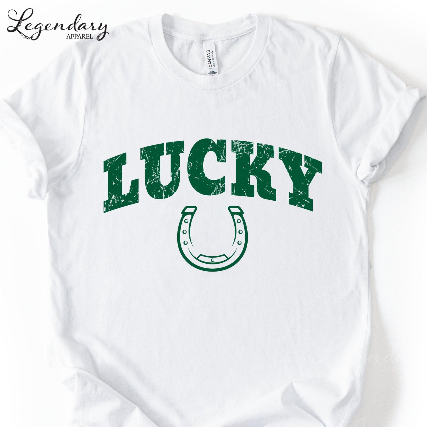 A white t-shirt with the word "Lucky" printed in green letters, along with a green horseshoe symbol.