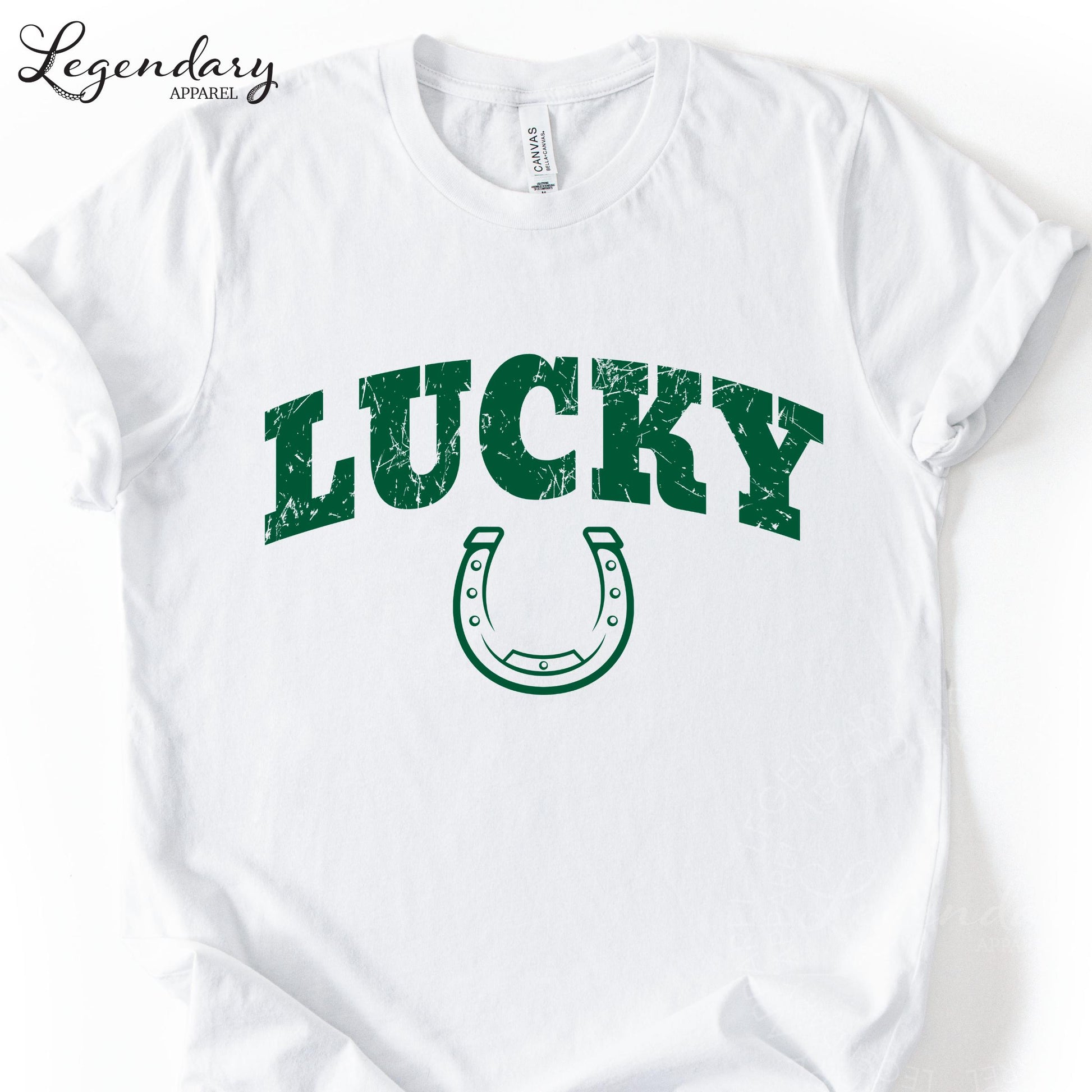 A white t-shirt with the word "Lucky" printed in green letters, along with a green horseshoe symbol.