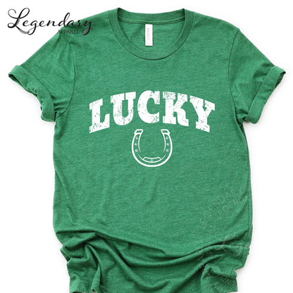 A green t-shirt with the word "Lucky" printed on it, along with a horseshoe symbol.