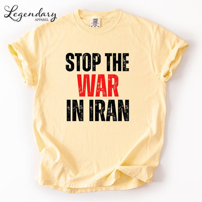 A yellow t-shirt with the text "STOP THE WAR IN IRAN" printed on it.
