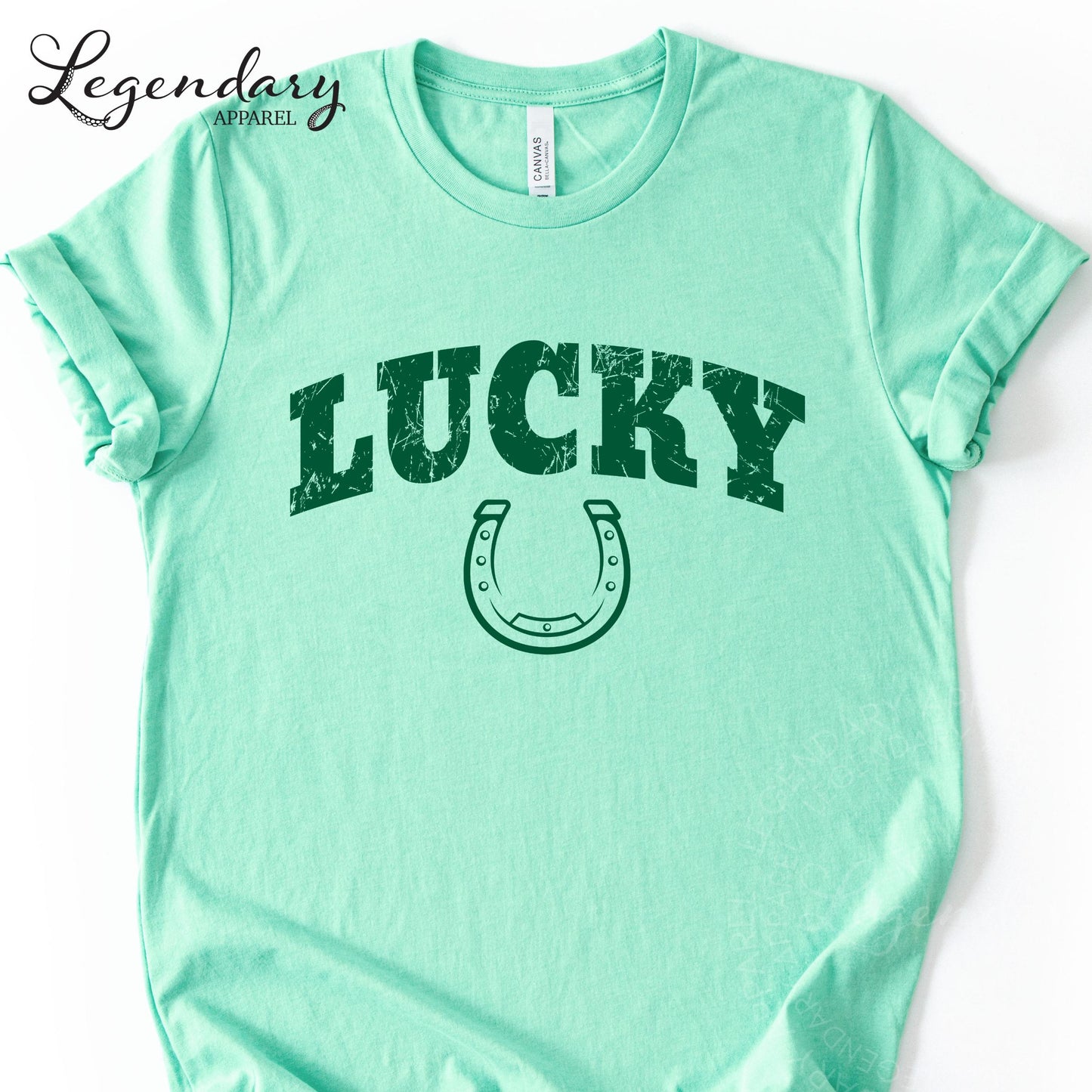 A mint green t-shirt with the word "Lucky" printed on it, along with a horseshoe graphic.