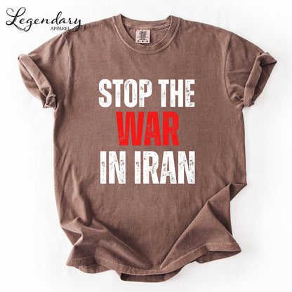A brown t-shirt with the text "STOP THE WAR IN IRAN" printed on it in white and red lettering.