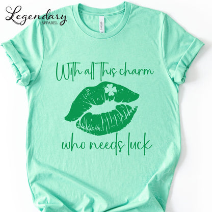 A mint green t-shirt with a graphic design of green lips and a clover on the tongue, along with the text "With all this charm who needs luck".