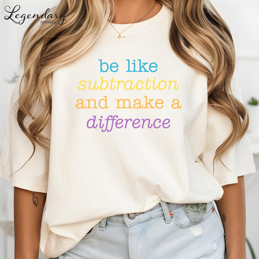 A woman wearing a white t-shirt with the text "be like subtraction and make a difference" printed on it.
