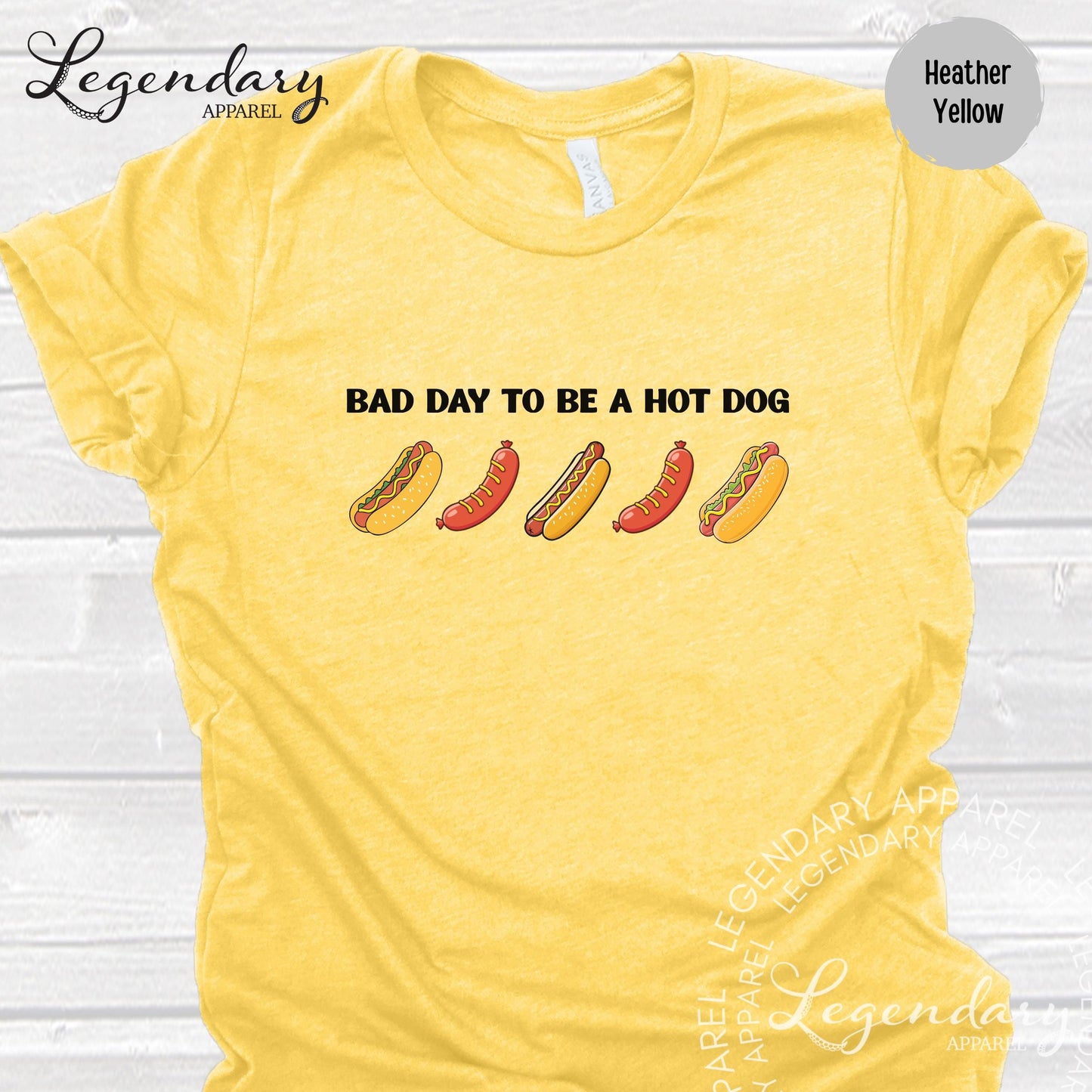 A yellow t-shirt with a humorous text and graphic design related to hot dogs.