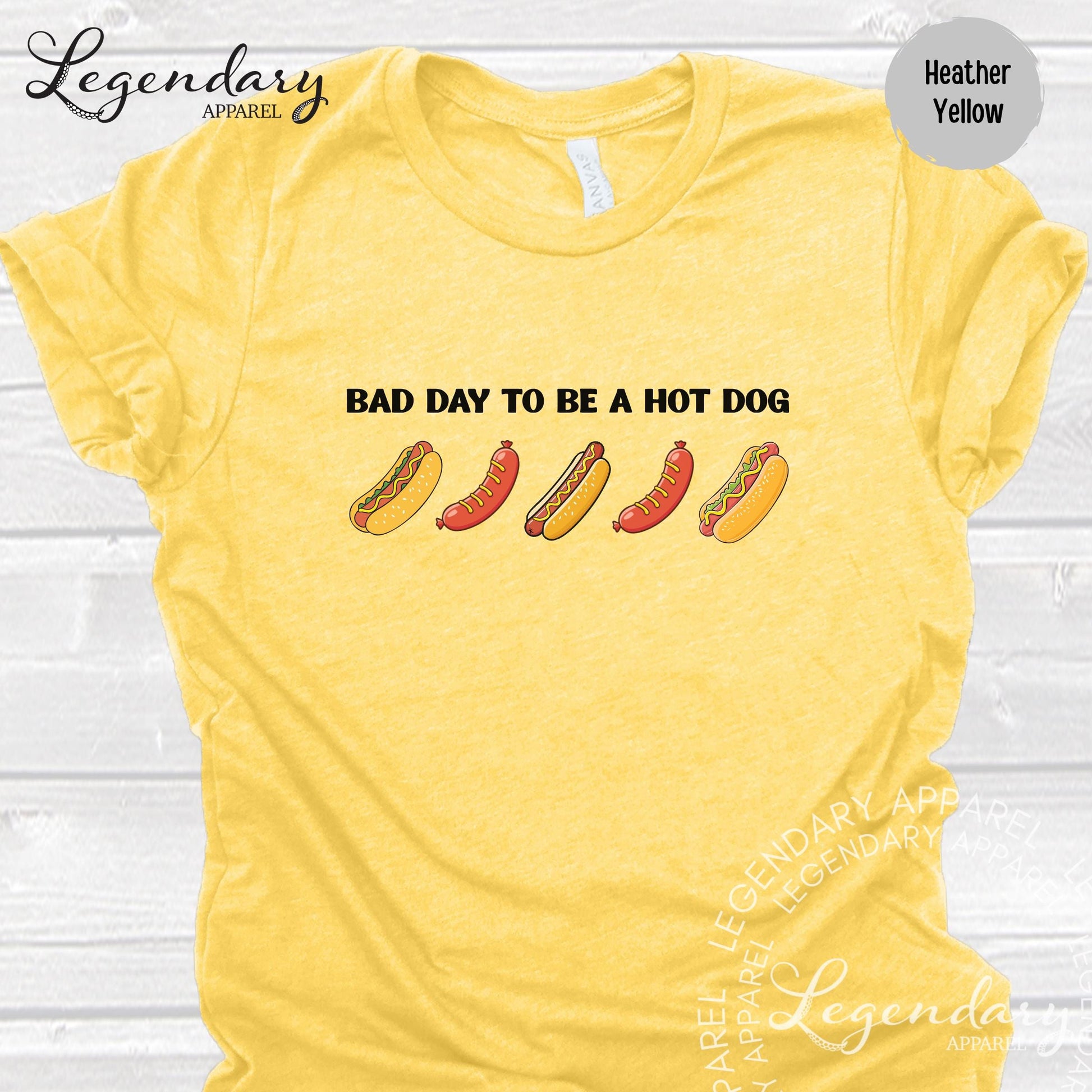 A yellow t-shirt with a humorous text and graphic design related to hot dogs.