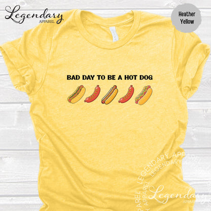 A yellow t-shirt with a humorous text and graphic design related to hot dogs.