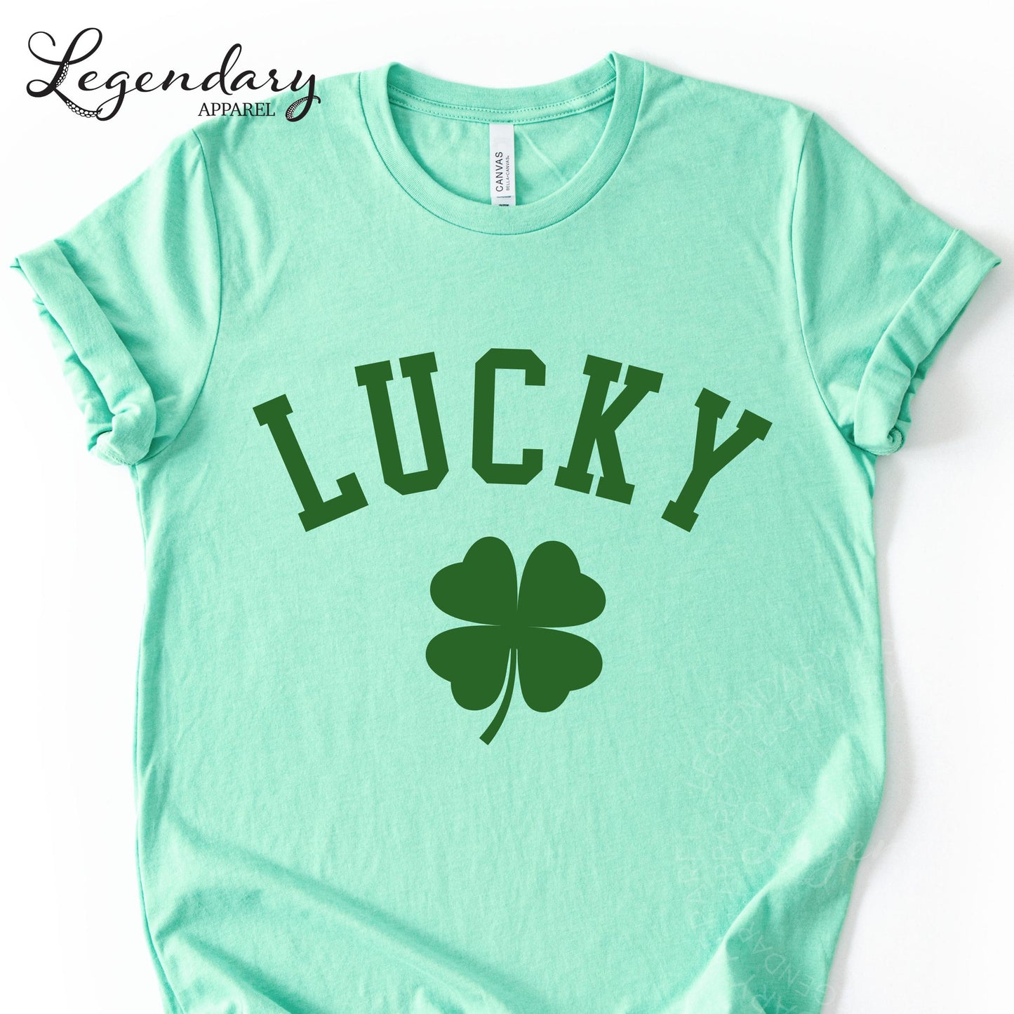 A mint green t-shirt with the word "Lucky" printed on it, along with a four-leaf clover symbol.