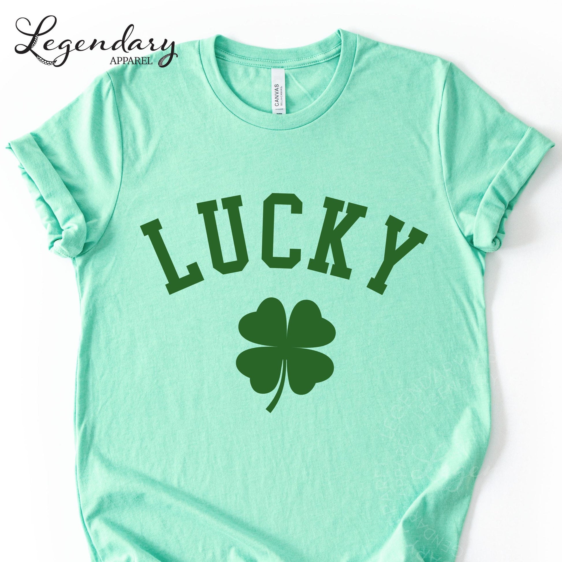 A mint green t-shirt with the word "Lucky" printed on it, along with a four-leaf clover symbol.