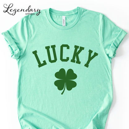 A mint green t-shirt with the word "Lucky" printed on it, along with a four-leaf clover symbol.