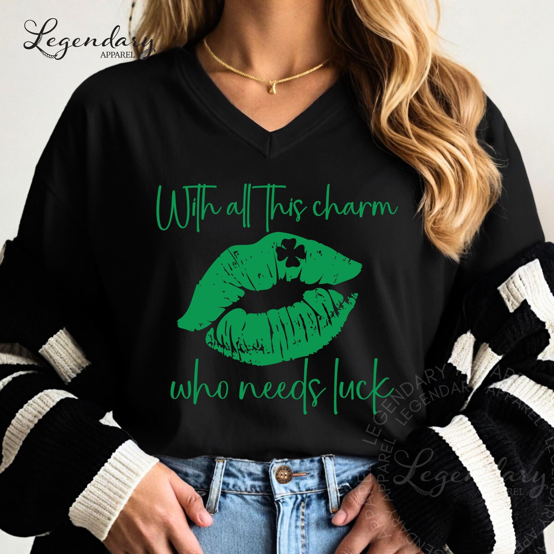 A woman wearing a black shirt with a graphic design of green lips and a clover on it, along with the text "With all this charm who needs luck".