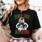 A woman wearing a black t-shirt with a graphic design of Santa Claus and the text &quot;Santa says six seven&quot; printed on it.
