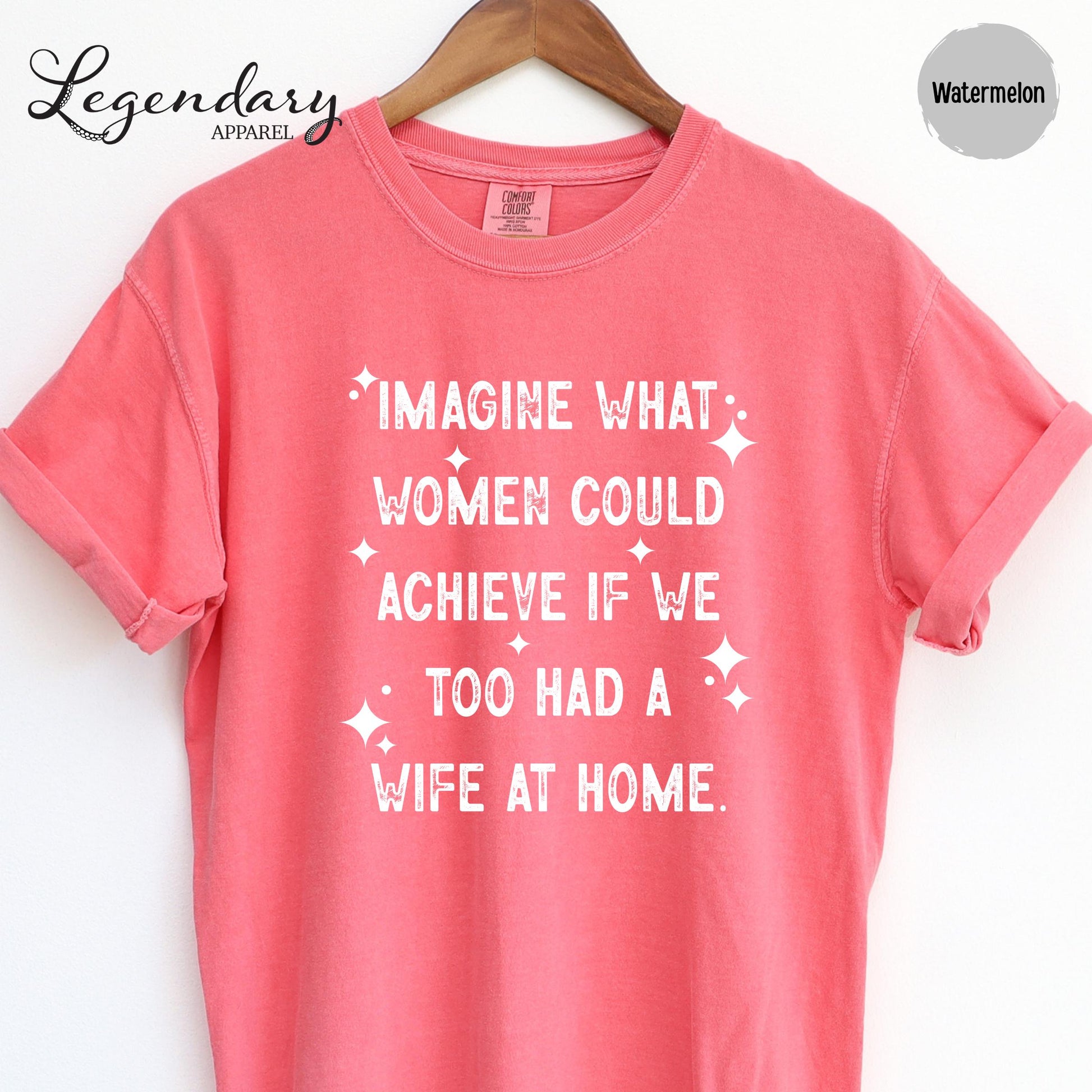 A pink t-shirt with white text printed on it.